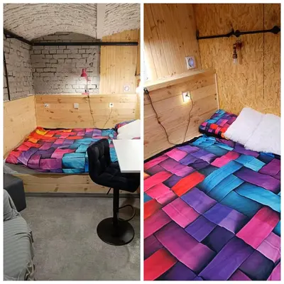 a bedroom with a colorful bed and a desk at Room 1 industrial in Kraków