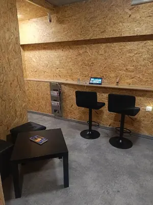 a waiting room with two chairs and a table at Room 1 industrial in Kraków