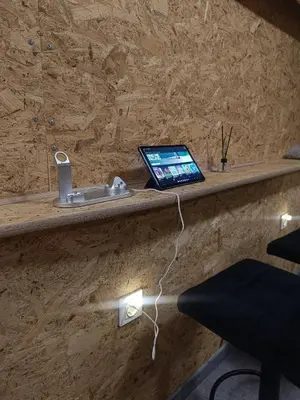 a laptop computer sitting on a counter next to a chair at Room 1 industrial in Kraków