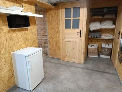 a white refrigerator in a room with a door at Room 1 industrial in Kraków