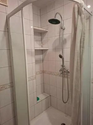 a shower with a glass door in a bathroom at Pokoje u Zbigniewa