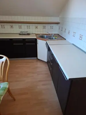 an empty kitchen with a sink and a counter at Pokoje u Zbigniewa