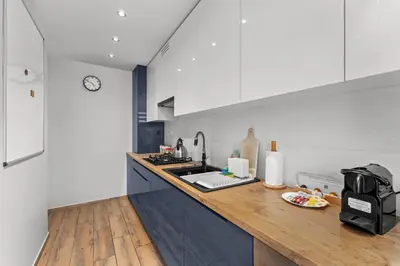 a kitchen with a counter with a sink and a microwave at Nad Sudołem Homely Apartment by BookingHost in Kraków