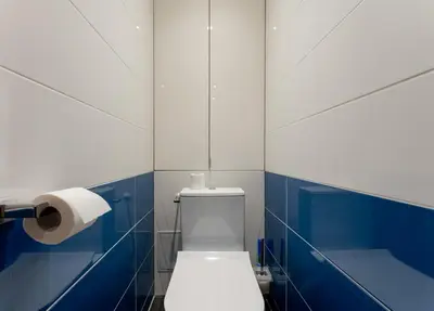 a bathroom with a toilet and a roll of toilet paper at Nad Sudołem Homely Apartment by BookingHost in Kraków