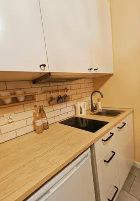 a kitchen with a sink and a counter top at Apartament Kataryniarza in Kraków