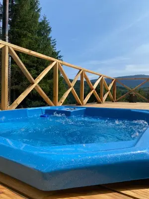 a blue tub sitting on top of a wooden deck at Brda 5 osobowa z jacuzzi in Zawoja