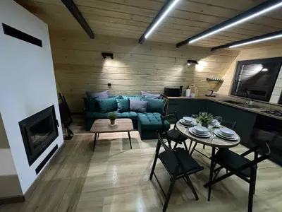 a living room with a couch and a table at Brda 5 osobowa z jacuzzi in Zawoja