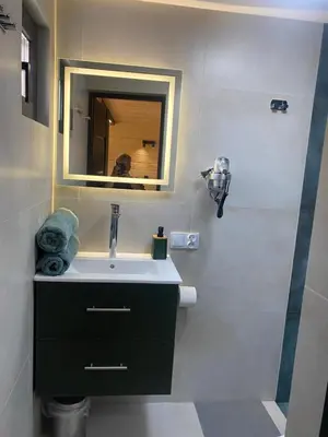 a bathroom with a sink and a mirror at Brda 5 osobowa z jacuzzi in Zawoja