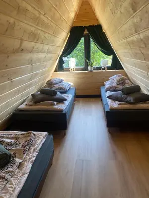 three beds in a room with a window at Brda 5 osobowa z jacuzzi in Zawoja