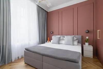 a bedroom with a large bed with pink walls at 4 Bedroom Apartment with Private Sauna and Parking in Kraków