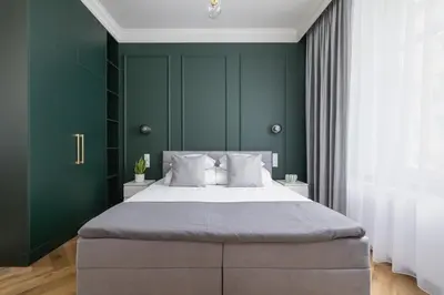 a bedroom with a large bed with green walls at 4 Bedroom Apartment with Private Sauna and Parking in Kraków