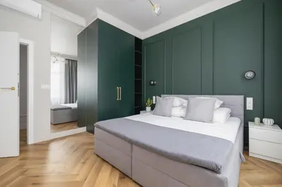 a bedroom with green walls and a large bed at 4 Bedroom Apartment with Private Sauna and Parking in Kraków