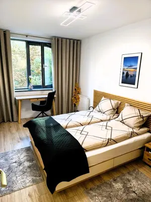 a bedroom with a large bed and a desk at Old Town Retreat Cracow in Kraków