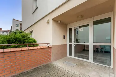 an entry to a building with glass doors at Pod Fortem Homely Apartment by BookingHost in Kraków