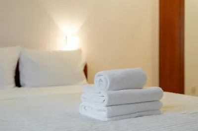 a pile of towels sitting on top of a bed at Pod Fortem Homely Apartment by BookingHost in Kraków