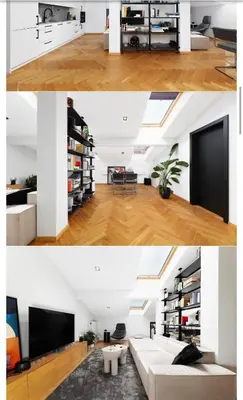 a living room with white walls and a white couch at M&D Apartment in Kraków