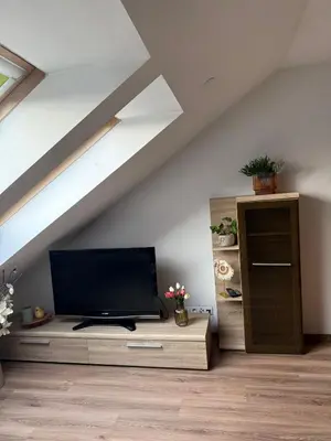 a living room with a flat screen tv on a wooden table at Vistula Apartment Kazimierz Old Town in Kraków