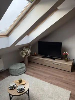a living room with a flat screen tv at Vistula Apartment Kazimierz Old Town in Kraków