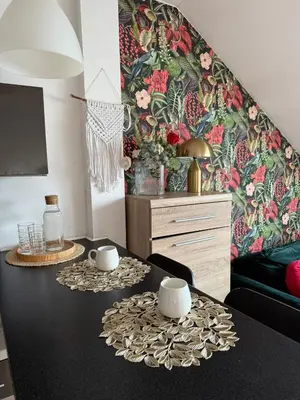 a living room with a table with two cups on it at Vistula Apartment Kazimierz Old Town in Kraków