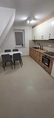 a kitchen with a table and chairs and a sink at W Rabczańskiej Dolinie 2 in Rabka