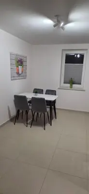 a dining room with a table and chairs and a window at W Rabczańskiej Dolinie 2 in Rabka