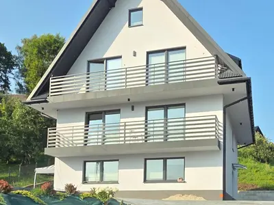 an image of a house with a balcony at W Rabczańskiej Dolinie 2 in Rabka