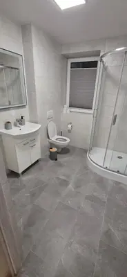 a bathroom with a shower and a toilet and a sink at W Rabczańskiej Dolinie 2 in Rabka