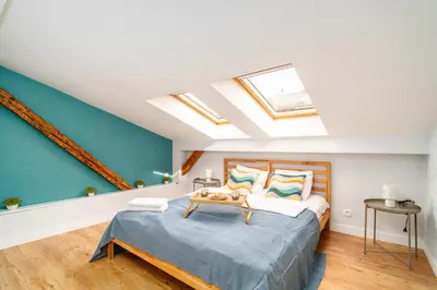 a bedroom with a bed with a table on it at Podgórze Studio - Air Con, Workdesk, Castle Nearby in Kraków