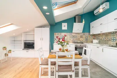 a kitchen and dining room with a table and chairs at Podgórze Studio - Air Con, Workdesk, Castle Nearby in Kraków