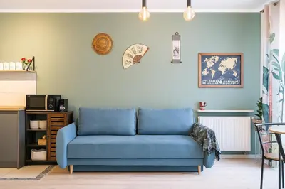 a blue couch sitting in a living room at Garden Spot and Parking in Kraków
