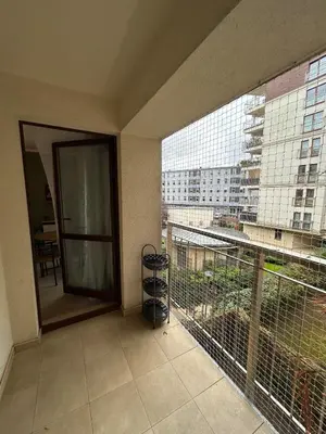 a room with a balcony with a view of a building at Garden Spot and Parking in Kraków