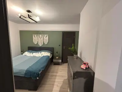 a bedroom with a bed and a dresser in it at Garden Spot and Parking in Kraków