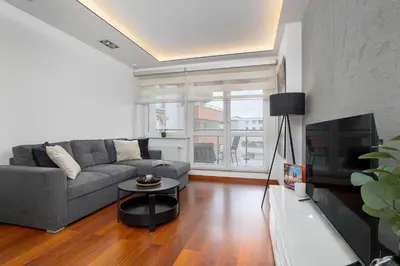 a living room with a couch and a tv at Modern Apartment with Desk and Balcony by Noclegi Renters in Kraków