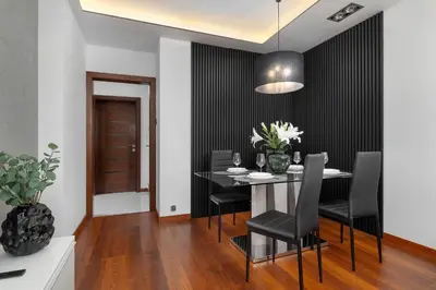 a dining room with a table with black chairs at Modern Apartment with Desk and Balcony by Noclegi Renters in Kraków