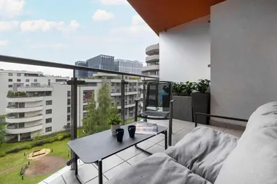 a balcony with a table and a view of a city at Modern Apartment with Desk and Balcony by Noclegi Renters in Kraków