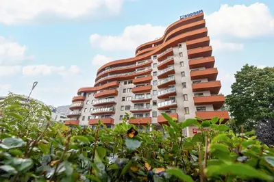 a building with a sunflower in front of it at Modern Apartment with Desk and Balcony by Noclegi Renters in Kraków
