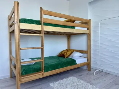 a bunk bedded room with a bunk bed with a ladder at Apartamenty Podlesie in Przeciszów