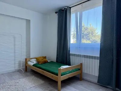 a small bed in a room with a window at Apartamenty Podlesie in Przeciszów