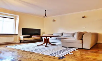a living room with a couch and a tv at Old Town Apt Józefa Street 22 in Kraków