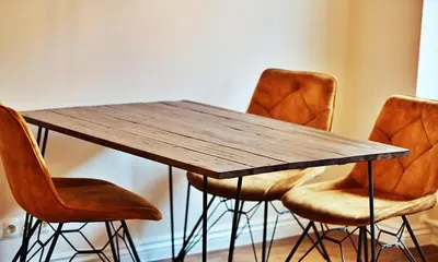 a wooden table with four chairs around it at Old Town Apt Józefa Street 22 in Kraków