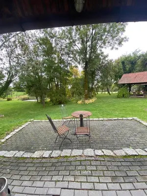 a table and two chairs on a brick patio at Karczma Siedlisko Pokoje Gościnne in Miechów