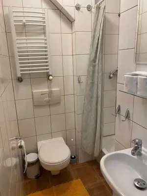 a bathroom with a toilet and a sink at Karczma Siedlisko Pokoje Gościnne in Miechów