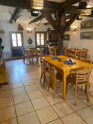 a dining room with wooden tables and chairs at Karczma Siedlisko Pokoje Gościnne in Miechów