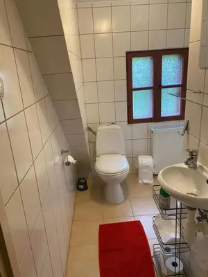 a small bathroom with a toilet and a sink at Karczma Siedlisko Pokoje Gościnne in Miechów