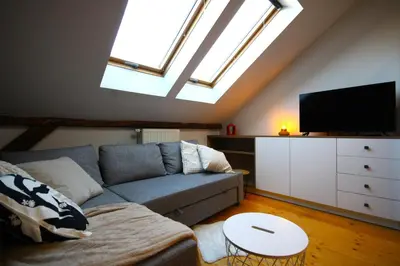 a living room with a couch and a flat screen tv at Atmospheric Apartment close to Old Town by Rently in Kraków