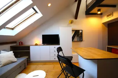 a loft conversions kitchen and living room with skylights at Atmospheric Apartment close to Old Town by Rently in Kraków