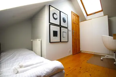 a bedroom with a bed and a sink and a window at Atmospheric Apartment close to Old Town by Rently in Kraków