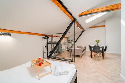 a living room with a white couch and a table at Old Town Siemieradzkiego Apartments by Hosty in Kraków