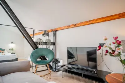 a living room with a couch and a tv at Old Town Siemieradzkiego Apartments by Hosty in Kraków