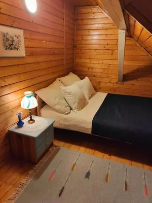 a bedroom with two beds and a table with a lamp at Sielanka, wyjątkowy dom, jacuzzi in Ślemień